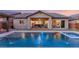 Stunning pool with water features and a covered patio at 7563 Saguaro Cactus Ave, Las Vegas, NV 89178