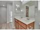 Double vanity bathroom with modern wood cabinets and a large mirror at 7564 Daniel Boone Ct, Las Vegas, NV 89166