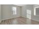 Bright bedroom with light gray walls and wood-look flooring at 7564 Daniel Boone Ct, Las Vegas, NV 89166