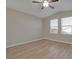 Spacious bedroom featuring wood-look floors and a ceiling fan at 7564 Daniel Boone Ct, Las Vegas, NV 89166