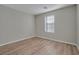 Spacious bedroom with neutral walls and wood-look vinyl flooring at 7564 Daniel Boone Ct, Las Vegas, NV 89166