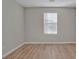 Simple bedroom featuring neutral walls and wood-look flooring at 7564 Daniel Boone Ct, Las Vegas, NV 89166