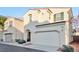 Two story house with a two car garage and landscaped front yard at 7564 Daniel Boone Ct, Las Vegas, NV 89166