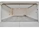 Open garage with overhead door and cement flooring at 7564 Daniel Boone Ct, Las Vegas, NV 89166