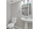 Small, clean powder room with pedestal sink and toilet at 7564 Daniel Boone Ct, Las Vegas, NV 89166