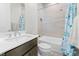 Bright bathroom with a combined shower and tub, white subway tile, and a decorative blue shower curtain at 8990 Rolling Pietra St, Las Vegas, NV 89166