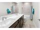 Bathroom with double sinks, a large mirror, and modern fixtures at 8990 Rolling Pietra St, Las Vegas, NV 89166