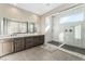 Elegant bathroom with a double vanity, large marble shower, and modern fixtures at 8990 Rolling Pietra St, Las Vegas, NV 89166