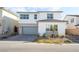 Two-story house with gray garage door and landscaping at 8990 Rolling Pietra St, Las Vegas, NV 89166