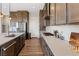 Modern kitchen with gray cabinets, stainless steel appliances, and a large center island at 8990 Rolling Pietra St, Las Vegas, NV 89166