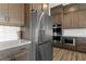 Well-equipped kitchen featuring stainless steel refrigerator and built-in oven and microwave at 8990 Rolling Pietra St, Las Vegas, NV 89166