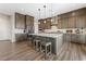 Stylish kitchen with a center island, pendant lighting, and stainless steel appliances at 8990 Rolling Pietra St, Las Vegas, NV 89166