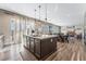 Kitchen island with seating overlooking living and dining areas at 8990 Rolling Pietra St, Las Vegas, NV 89166