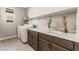 Laundry room with built-in cabinets and sink at 8990 Rolling Pietra St, Las Vegas, NV 89166