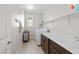 Well-lit laundry room with white washer and dryer, white countertops, and functional storage solutions at 8990 Rolling Pietra St, Las Vegas, NV 89166