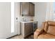 Wet bar featuring sink, mini fridge, and storage cabinets for entertaining at 8990 Rolling Pietra St, Las Vegas, NV 89166