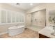 Elegant bathroom featuring a soaking tub and large walk-in shower at 9121 Las Manaitas Ave # 401, Las Vegas, NV 89144