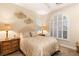 Bedroom with arched window and neutral-toned bedding at 9121 Las Manaitas Ave # 401, Las Vegas, NV 89144