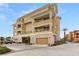 Condo building showcasing multiple levels, garages, and ample parking at 9121 Las Manaitas Ave # 401, Las Vegas, NV 89144