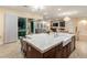 Large kitchen island with farmhouse sink and breakfast bar at 9121 Las Manaitas Ave # 401, Las Vegas, NV 89144