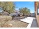 Landscaped backyard with a large concrete patio area at 9272 Cantana St, Las Vegas, NV 89123