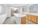 Kitchen with light wood cabinets, white countertops, and island at 9272 Cantana St, Las Vegas, NV 89123