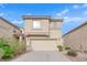 Two-story house with a beige facade and attached garage at 10646 Shifting Breeze Ave, Las Vegas, NV 89129