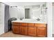 Bathroom with double vanity and wood cabinets at 1066 Elation Ln # 103, Henderson, NV 89002