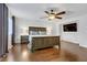 Main bedroom with wood floors, large bed, and ceiling fan at 1313 Alamosa Ridge Ct, North Las Vegas, NV 89084