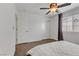 Bedroom with double doors leading to the closet, hardwood floors and ceiling fan at 1313 Alamosa Ridge Ct, North Las Vegas, NV 89084