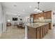 Gourmet kitchen with large island, granite counters, and wood cabinets at 1313 Alamosa Ridge Ct, North Las Vegas, NV 89084