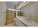 Clean bathroom with double vanity, granite countertop, and walk-in shower at 2736 Hartwick Pines Dr, Henderson, NV 89052