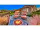 Backyard firepit with seating and mountain views at 2736 Hartwick Pines Dr, Henderson, NV 89052