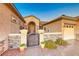 Elegant front entrance with wrought iron gate and stone accents at 2736 Hartwick Pines Dr, Henderson, NV 89052