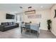 Elegant dining area with a gray table set and modern light fixture at 3665 Bronco Rd, Las Vegas, NV 89103