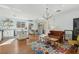 Open concept kitchen and living room with hardwood floors, island, and chandelier at 3817 Honey Ridge Ct, Las Vegas, NV 89135