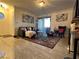 Living room with comfortable seating and access to balcony at 4050 Pacific Harbors Dr # 133, Las Vegas, NV 89121