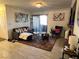 Spacious living room with fireplace and access to a patio at 4050 Pacific Harbors Dr # 133, Las Vegas, NV 89121