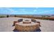 Landscaped backyard with a fire pit and a stunning city view at 7192 Polita Ct, Las Vegas, NV 89156