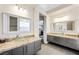 Elegant bathroom with double sinks, granite counters, and a large mirror at 7192 Polita Ct, Las Vegas, NV 89156