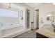 Spa-like bathroom with a large soaking tub, walk-in shower, and granite vanity at 7192 Polita Ct, Las Vegas, NV 89156