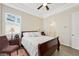 Bright bedroom with a sleigh bed, ceiling fan, and ensuite bathroom at 7192 Polita Ct, Las Vegas, NV 89156