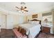Bright bedroom with wood flooring and ceiling fan at 7192 Polita Ct, Las Vegas, NV 89156