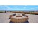 Outdoor fire pit with brick surround on a spacious patio, perfect for entertaining and enjoying scenic views at 7192 Polita Ct, Las Vegas, NV 89156