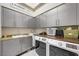 Bright laundry room with modern washer, dryer, and cabinets at 7192 Polita Ct, Las Vegas, NV 89156