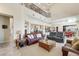 Bright living room with high ceilings, leather sofas, and views of the kitchen at 7192 Polita Ct, Las Vegas, NV 89156