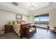 Main bedroom with a king-size bed and sliding doors leading to a balcony at 7192 Polita Ct, Las Vegas, NV 89156