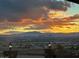 Panoramic sunset view from the house showing city lights on the horizon and dramatic cloud formations at 7192 Polita Ct, Las Vegas, NV 89156