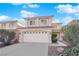 Two-story house with a white garage door and landscaped yard at 7640 Ribbon Garland Ct, Las Vegas, NV 89139