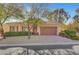 Single-story home with attractive landscaping and a two-car garage at 7937 Base Camp Ave, Las Vegas, NV 89178